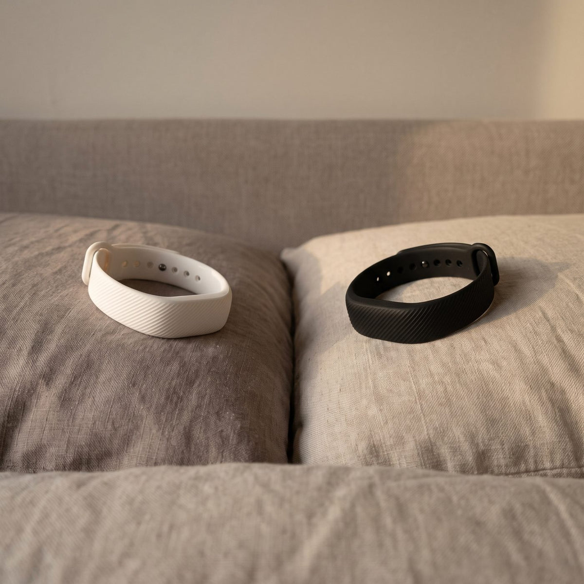 A white band on one pillow and a black band on the other.